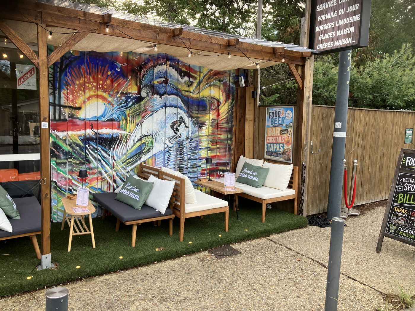 La terrasse sous la pergola et sa fresque de surf